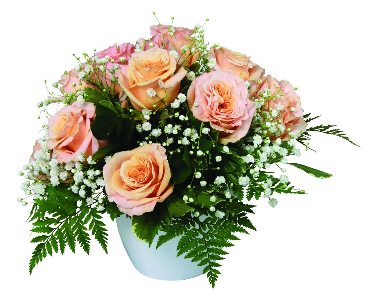 A fresh arrangement with pink roses, baby's breath and greens.