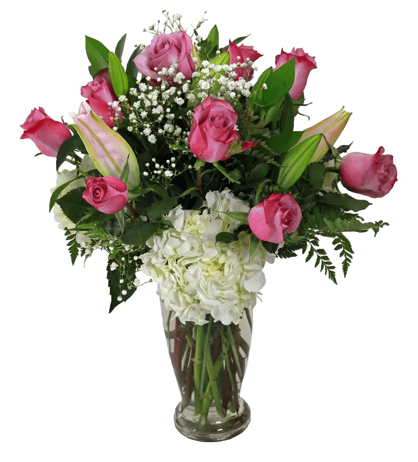 A vase arrangement with pink roses and lilies, white hydrangea, greens and fillers.
