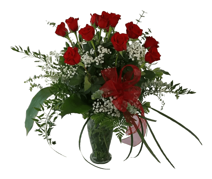 A dozen long stemmed red roses with greens and fillers in a vase.