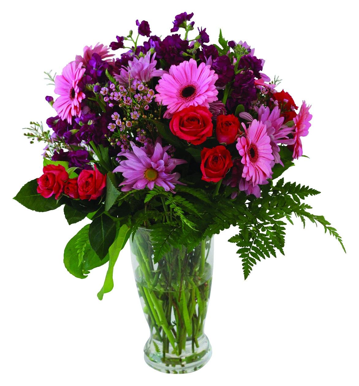A vase arrangement with red roses, pink mini gerberas and mums, greens and fillers.