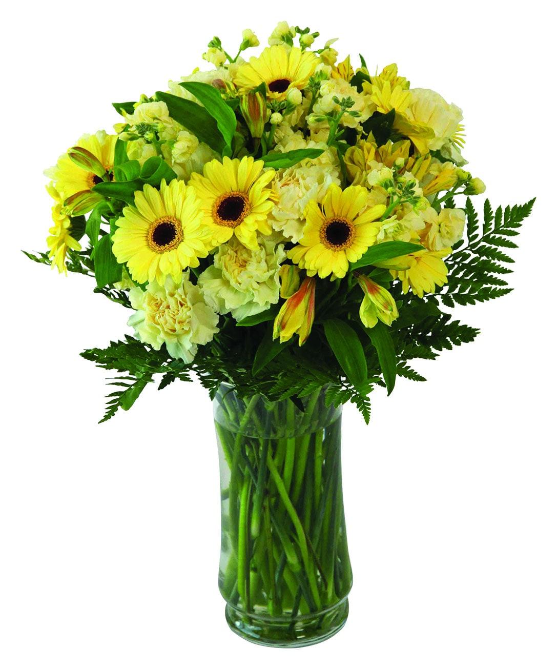 A vase arrangement with yellow alstromeria, carnations, gerberas, greens and fillers.