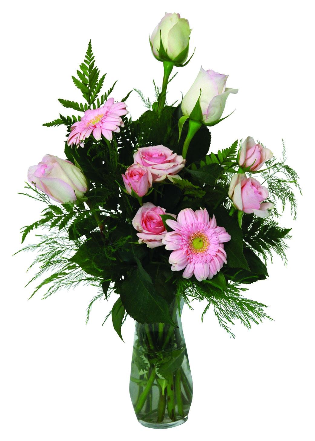 A one sided vase arrangement with pink roses, mini gerberas, greens and fillers.