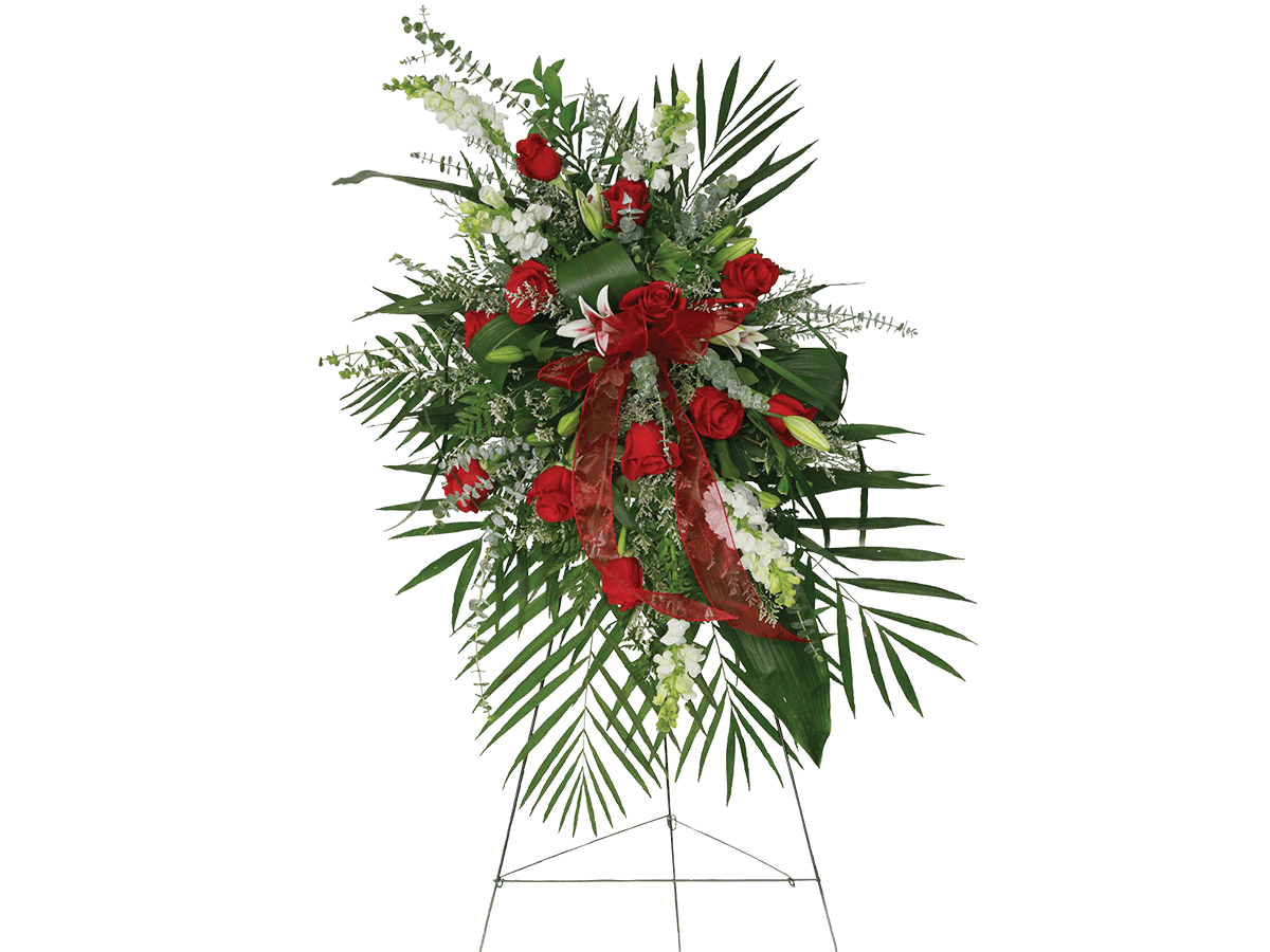 A standing spray with red roses, white snapdragons, pink lilies and greens.